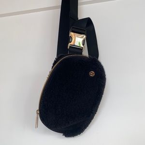 Lululemon Black Sherpa belt bag with gold accents